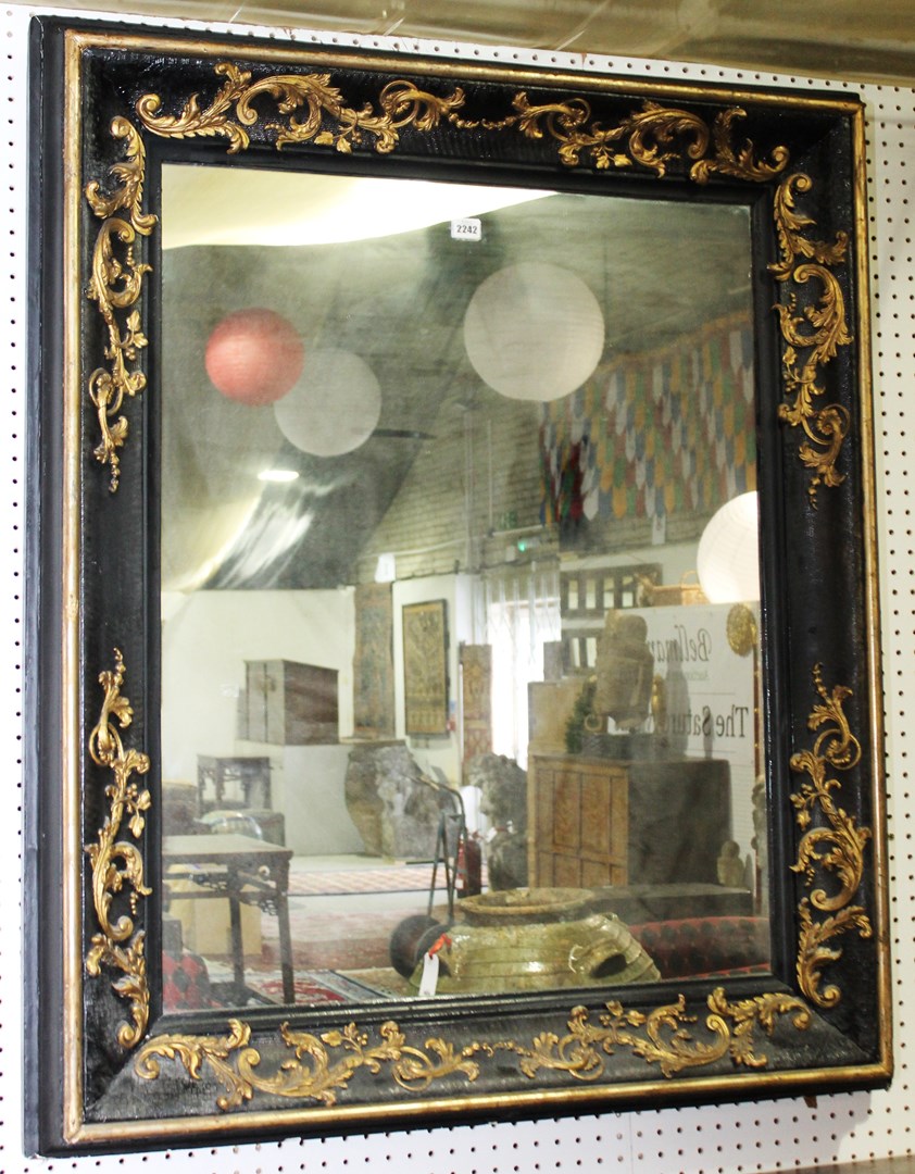 Appraisal: A th century and later parcel gilt ebonised wall mirror