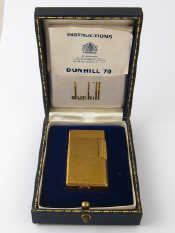 Appraisal: A Dunhill gold plated gas lighter in original presentation box