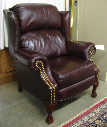 Appraisal: BURGUNDY LEATHER WINGBACK ARMCHAIR Chippendale style Lane Furniture Co recent