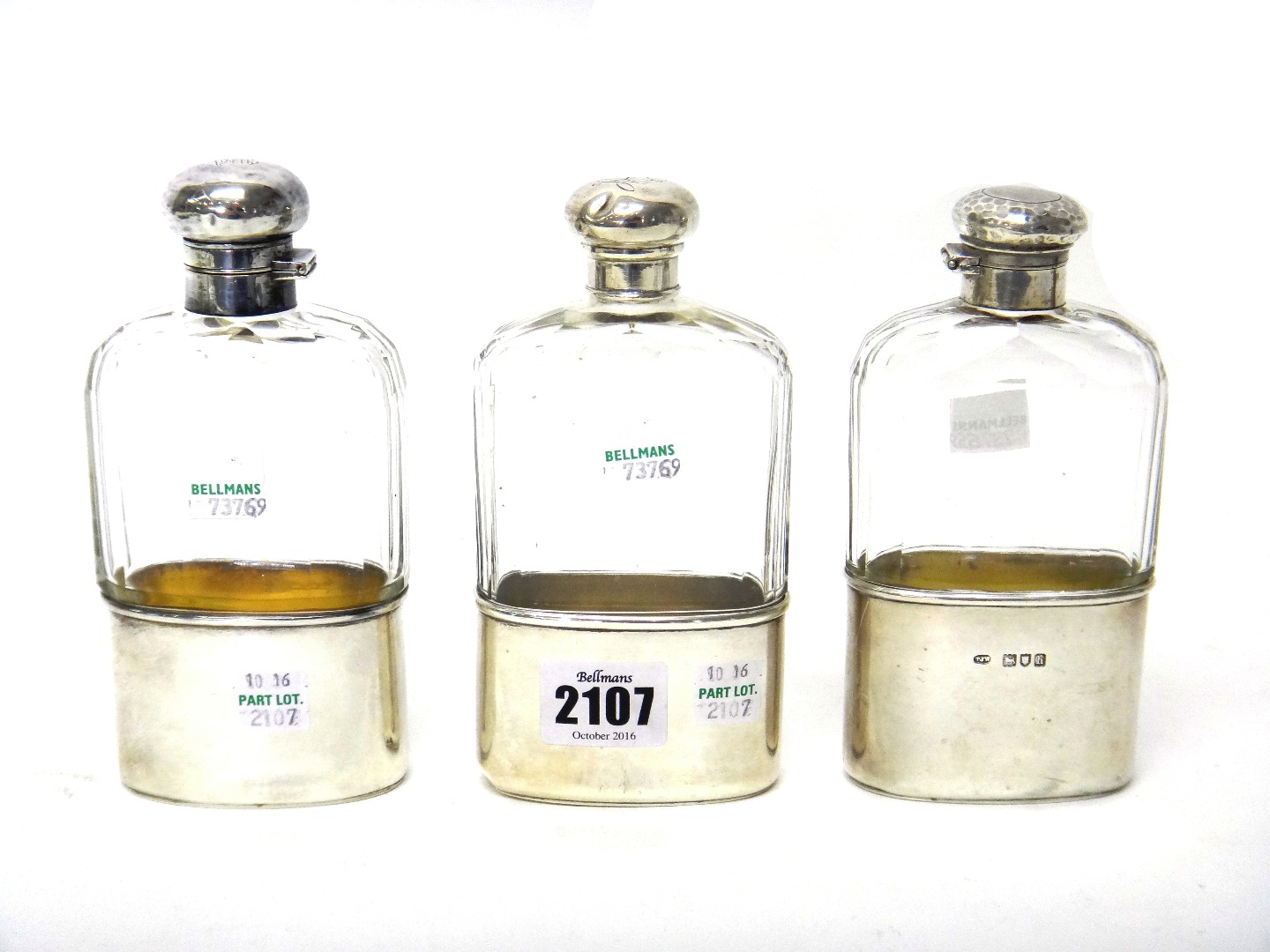 Appraisal: Three silver mounted faceted glass spirit flasks with pull-off beaker