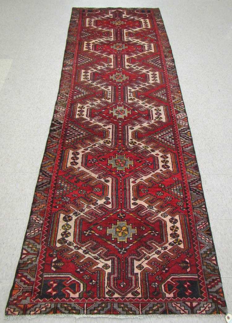 Appraisal: SEMI-ANTIQUE PERSIAN TRIBAL AREA RUG featuring a column of six