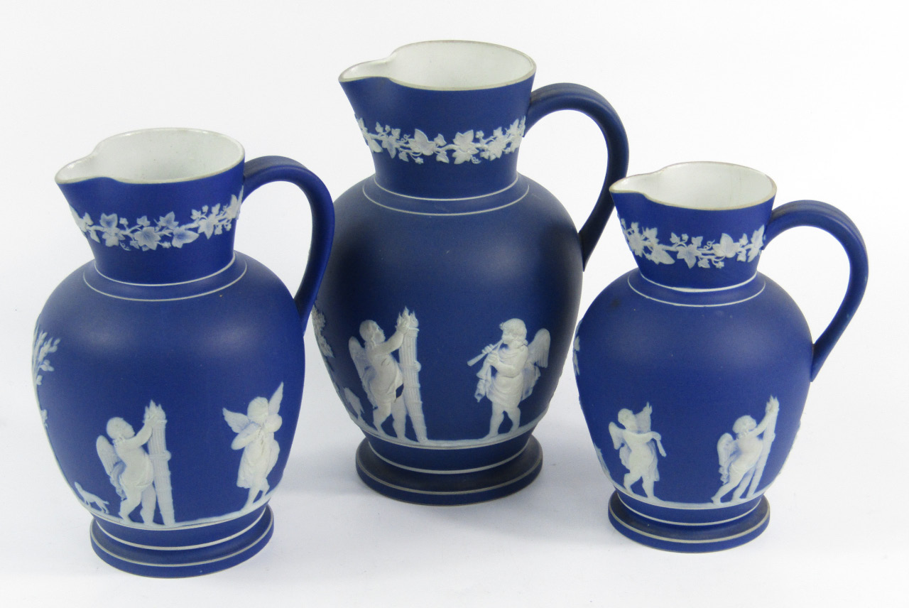 Appraisal: A graduated set of three blue Jasperware jugs late th