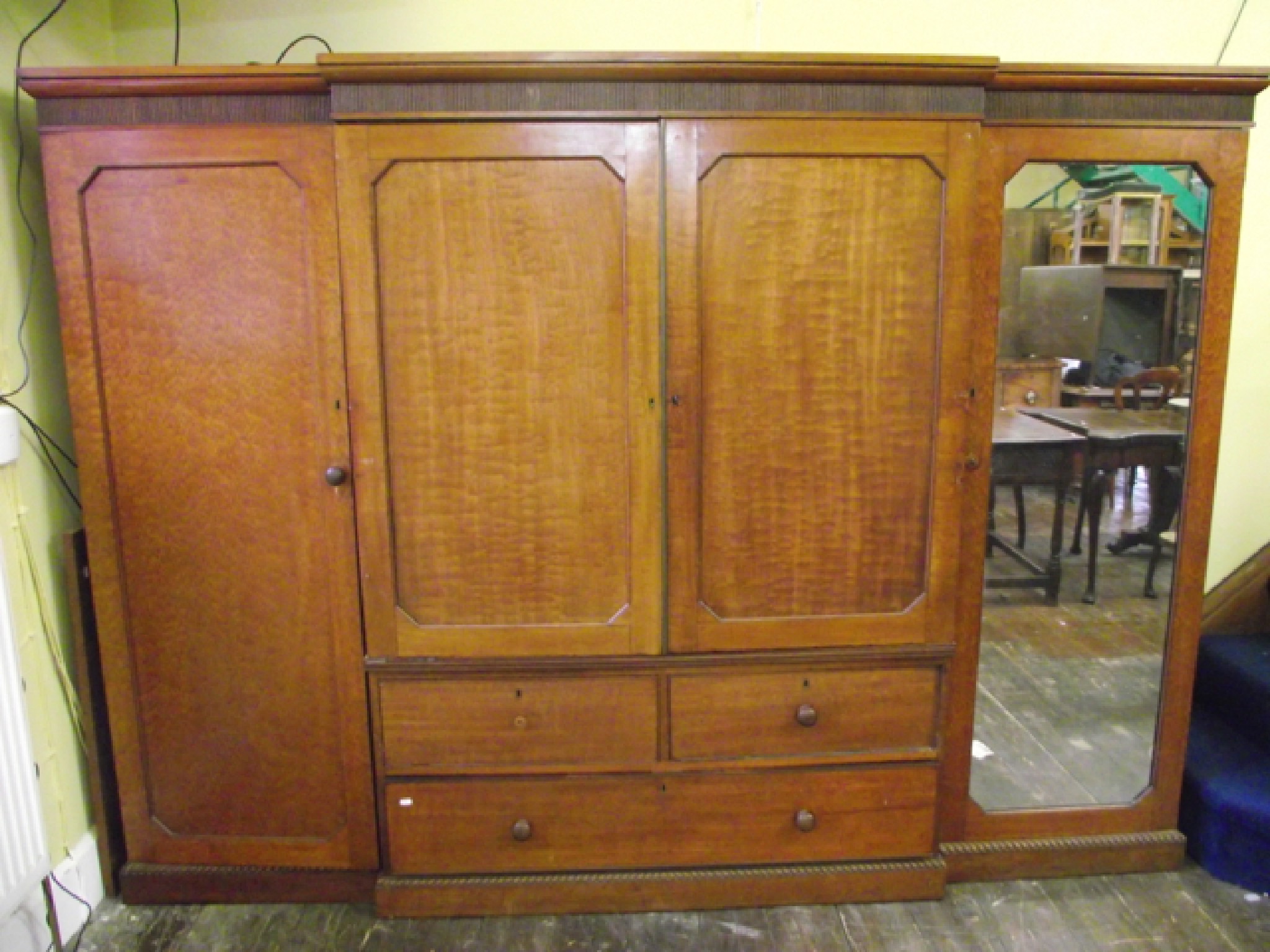 Appraisal: A Regency mahogany four door breakfront wardrobe the centre section