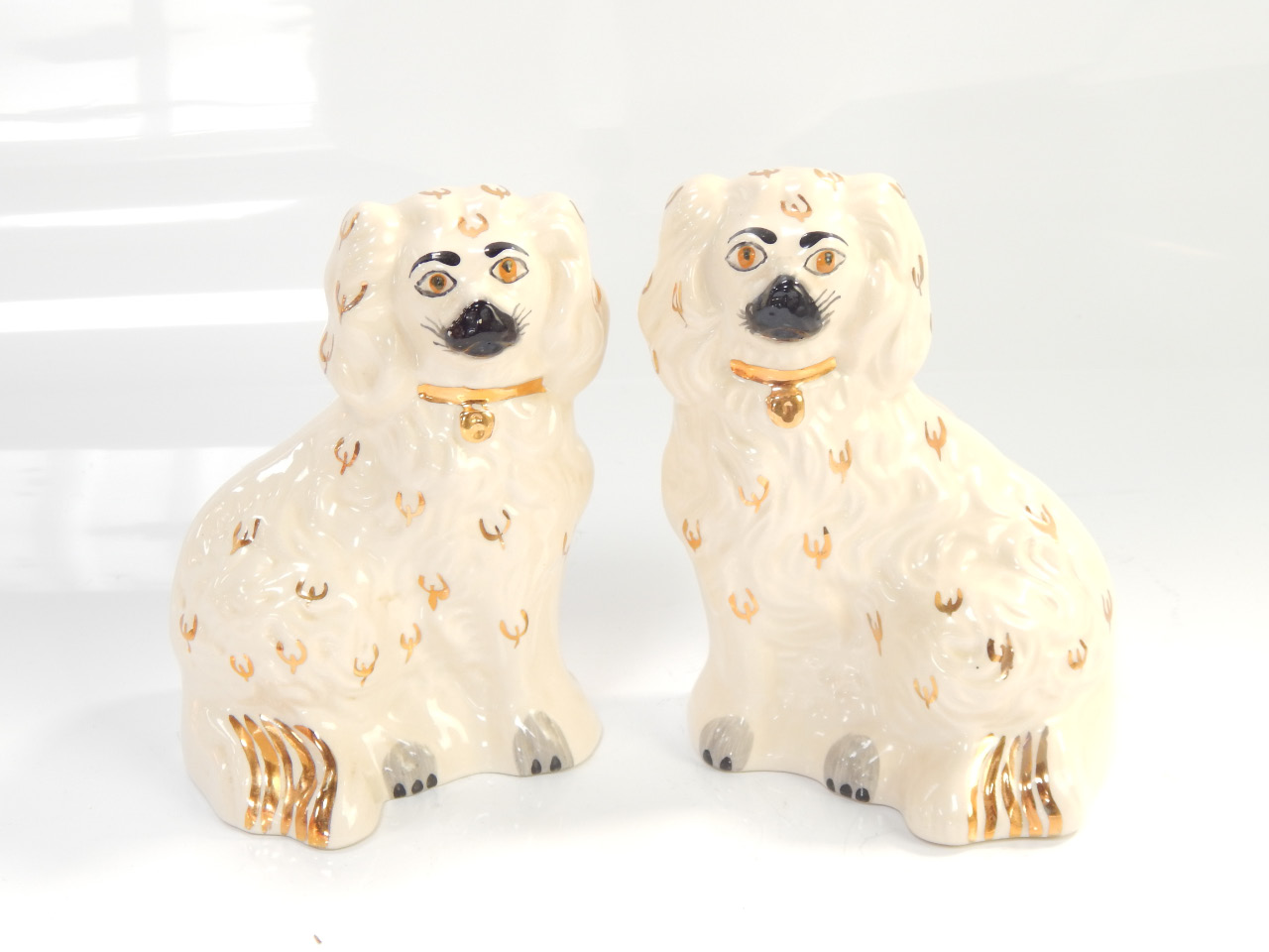 Appraisal: A pair of Beswick fireside companion spaniels cm high