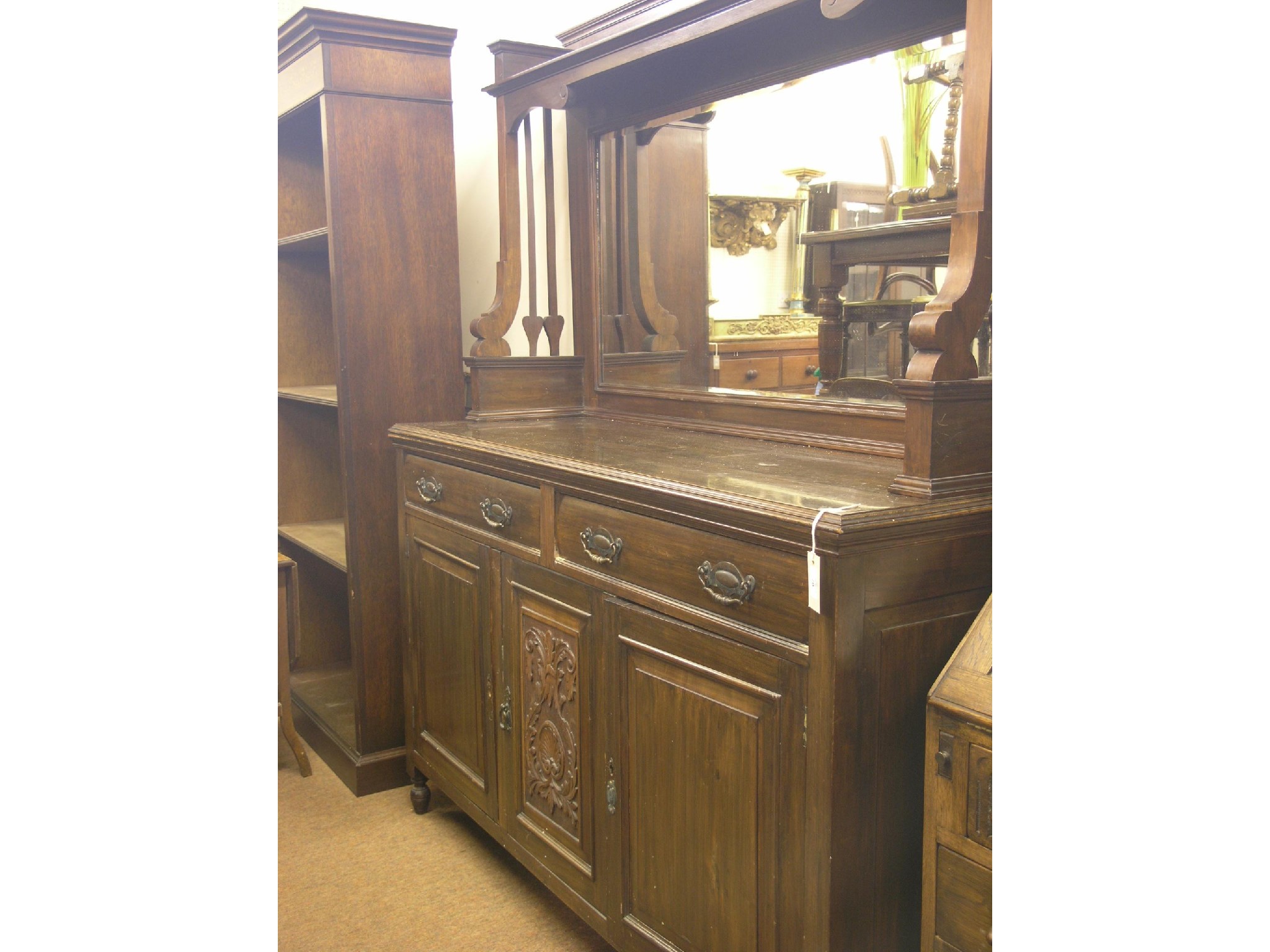 Appraisal: A late Victorian dark walnut sideboard bevelled mirror back with