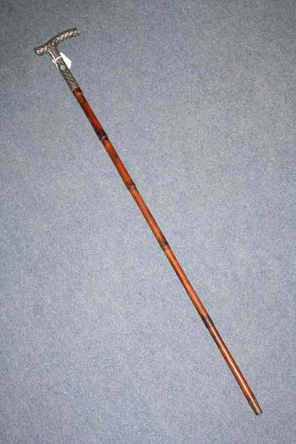 Appraisal: A CONTINENTAL SILVER HANDLED WALKING STICK woven decoration and inset