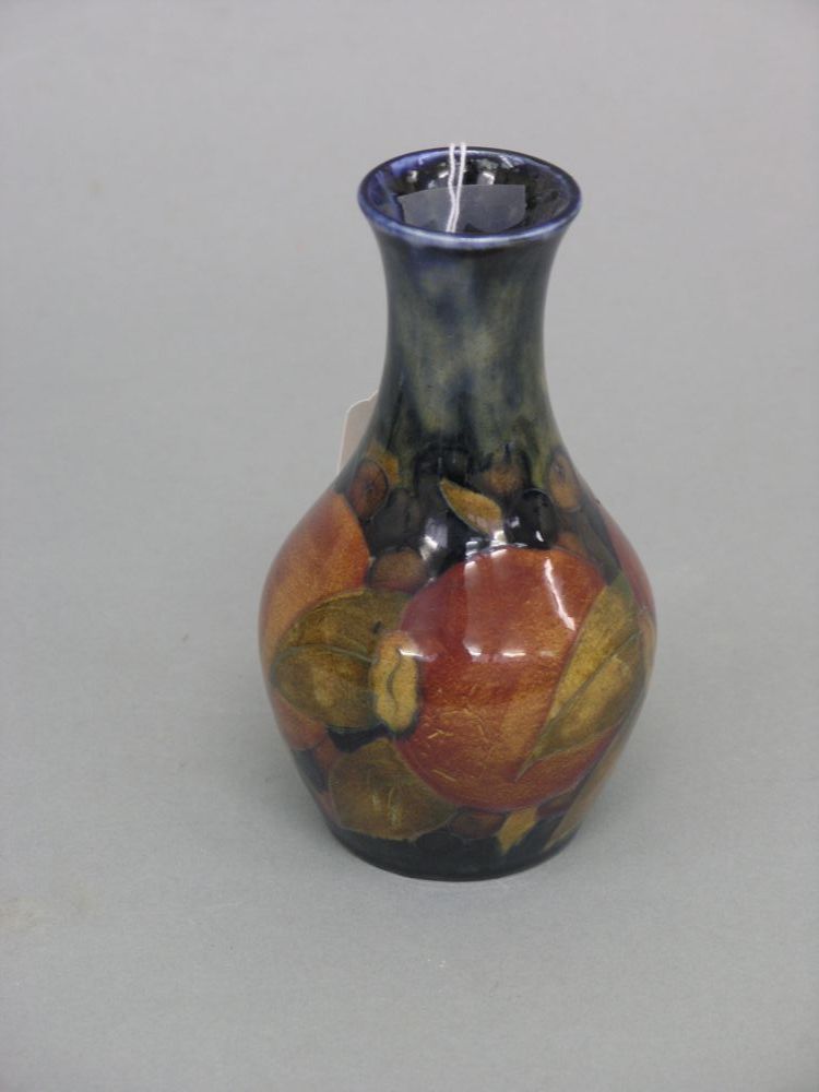 Appraisal: A Moorcroft vase 'Pomegranate' bulbous shape against a deep blue