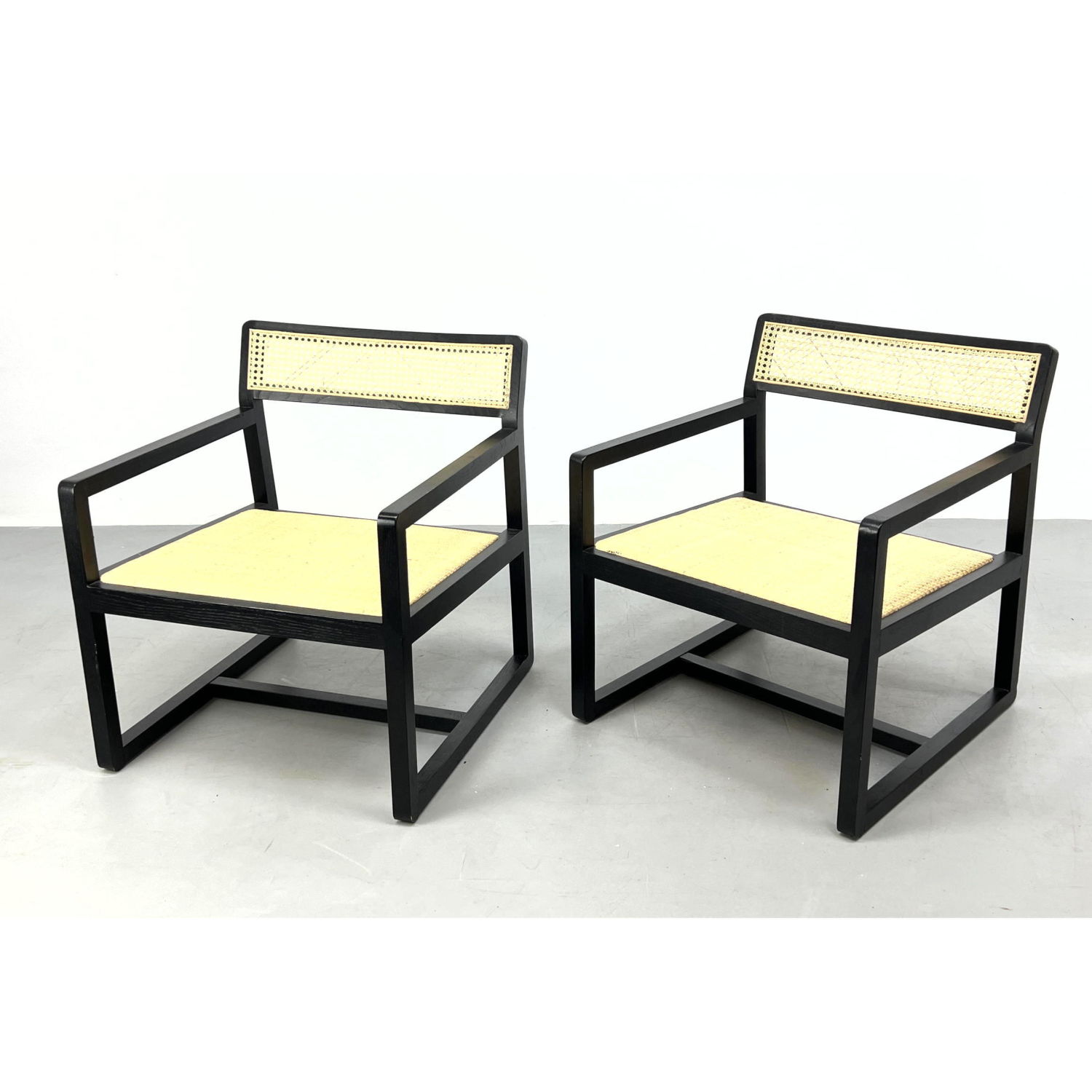 Appraisal: Pr Ebonized Frame Open Arm Lounge Chairs Modernist form seating