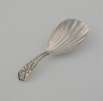 Appraisal: A George III caddy spoon with a fluted bowl bright-cut