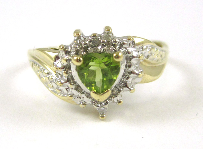 Appraisal: PERIDOT DIAMOND AND TEN KARAT GOLD RING with round-cut diamonds