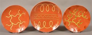 Appraisal: Three Breininger Pottery Slip Decorated Plates and - diam