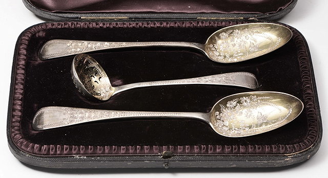 Appraisal: A PAIR OF VICTORIAN SILVER SERVING SPOONS the handles engraved