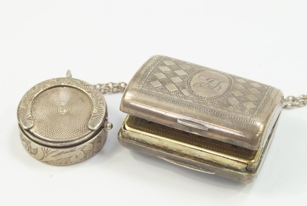 Appraisal: An Edwardian silver sovereign case Birmingham on chain together with