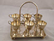 Appraisal: A silver plated egg cup stand with six cups