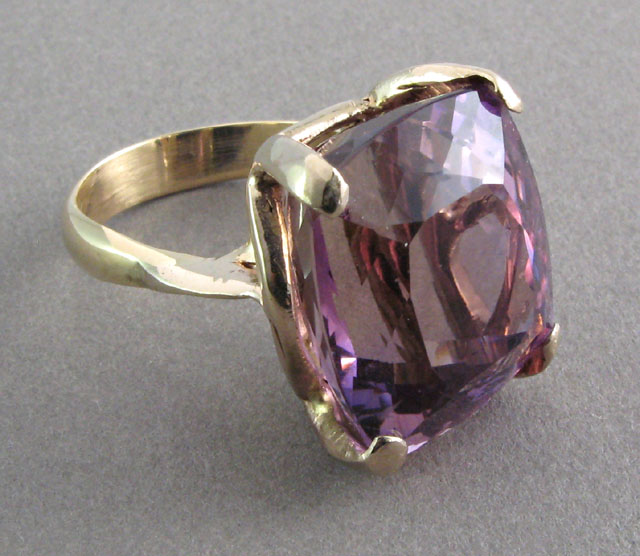 Appraisal: AMETHYST AND FOURTEEN KARAT GOLD RING set with a cushion