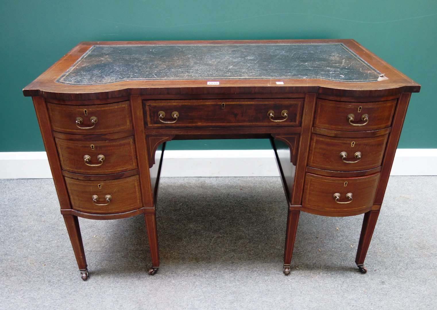 Appraisal: An Edwardian inlaid mahogany double bowfront writing desk with seven