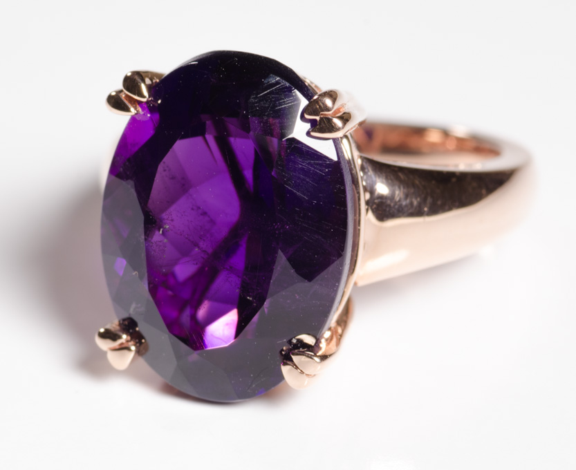 Appraisal: AN AMETHYST AND FOURTEEN KARAT GOLD SOLITAIRE RING a -prong