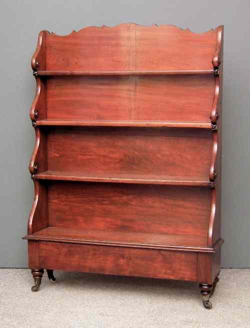 Appraisal: A Victorian mahogany ''Waterfall'' bookcase with shaped top and sides