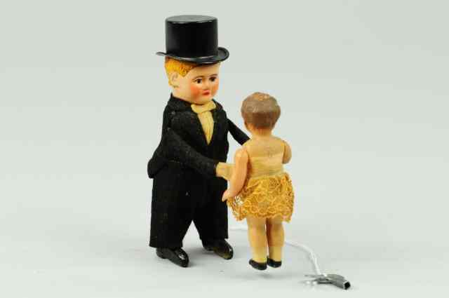 Appraisal: BOY IN TUX WITH GIRL Schuco Germany clockwork driven boy