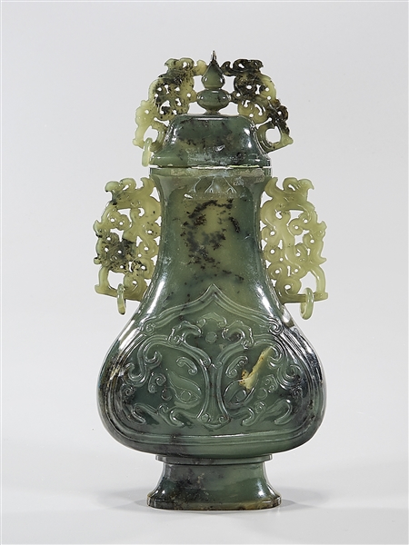 Appraisal: Chinese carved jade covered vase with mask faces in relief