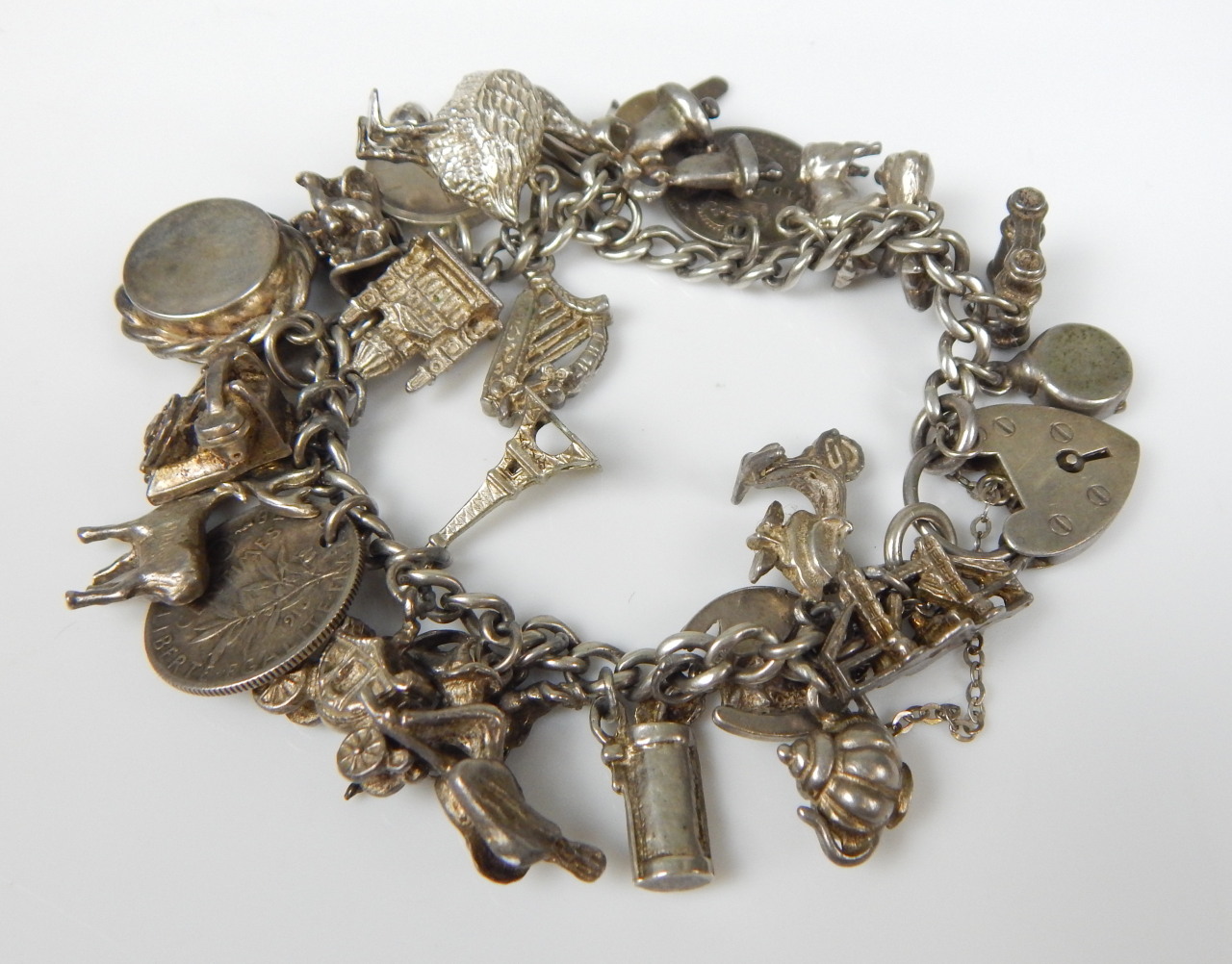 Appraisal: A charm bracelet with various charms to include compass goose