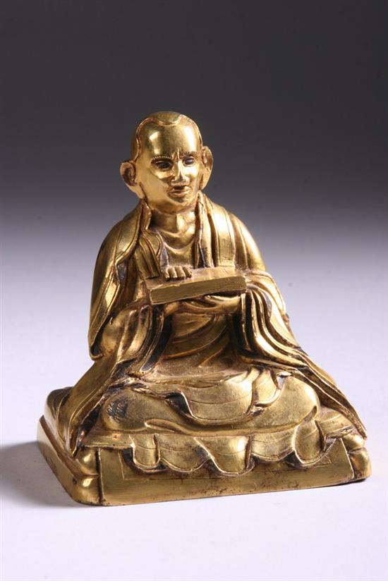 Appraisal: CHINESE GILT BRONZE FIGURE OF MONK Holding book wearing long