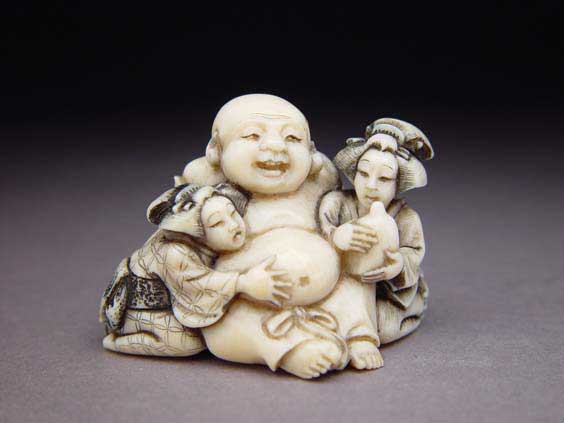 Appraisal: CARVED IVORY NETSUKE Finely carved ivory netsuke of a seated