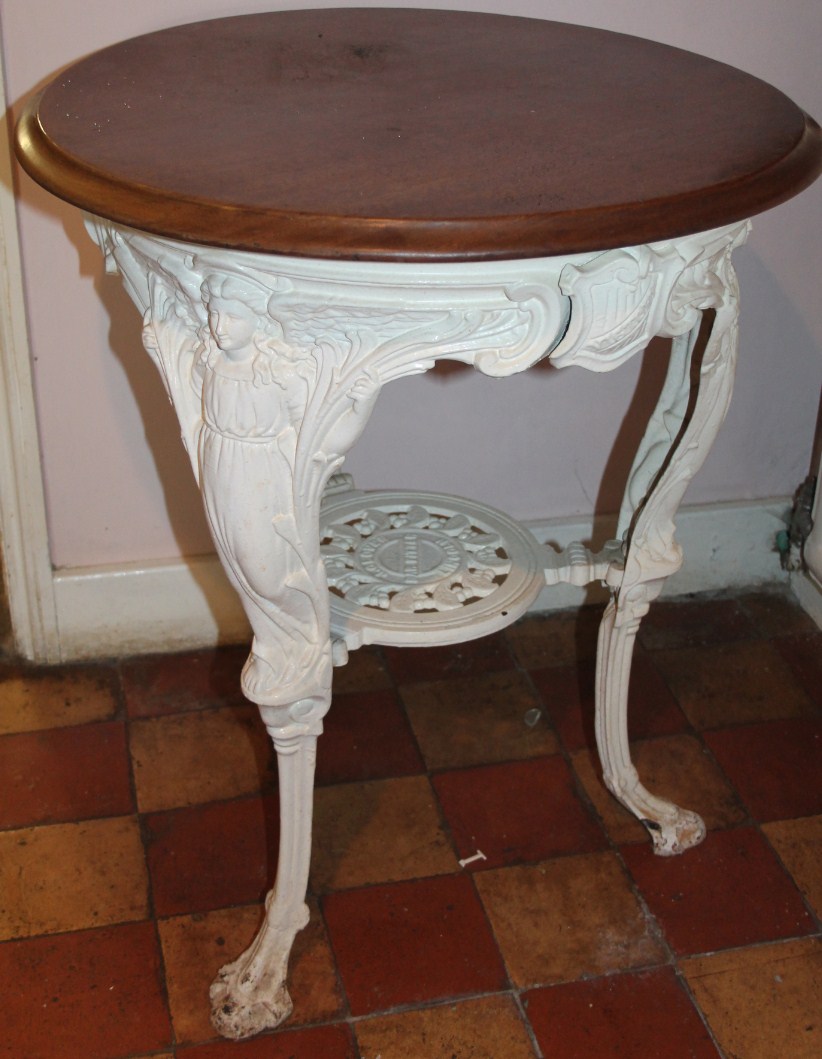 Appraisal: A cast metal Britannia type pub table with circular mahogany