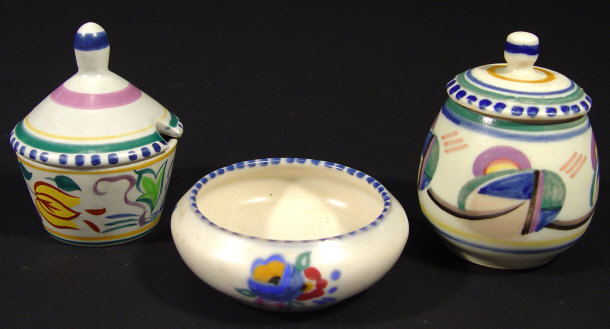 Appraisal: Two Poole Pottery preserve pots and covers painted with stylised