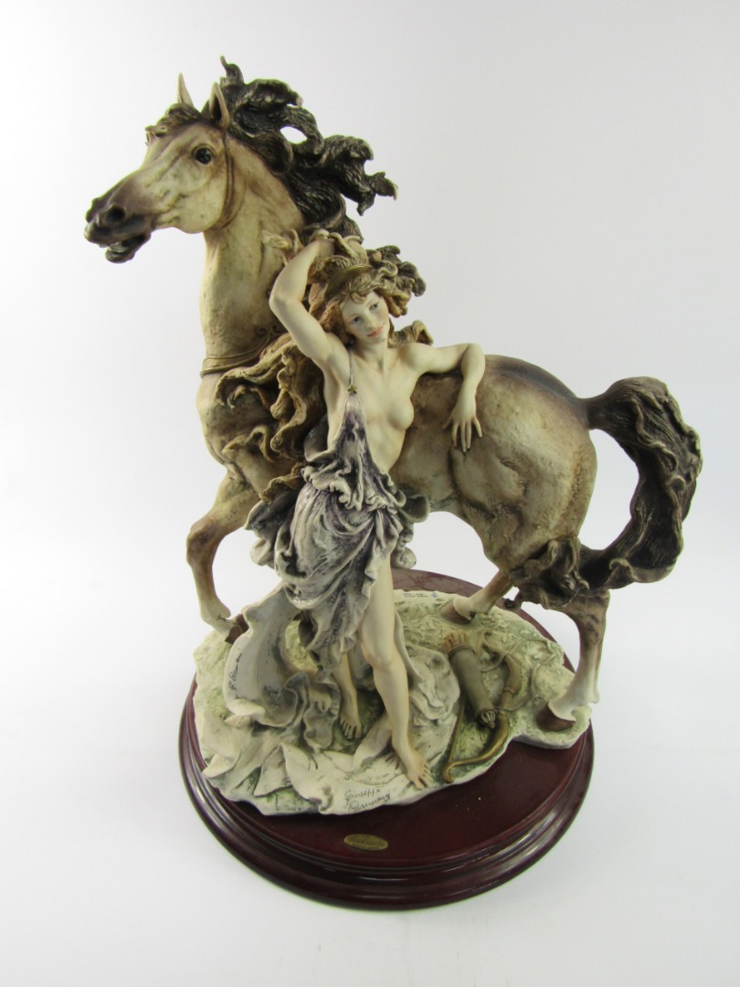 Appraisal: A Capodimonte Florence figure group of a semi-clad woman and