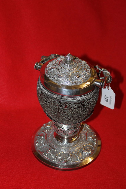 Appraisal: A BURMESE WHITE METAL SILVER CUP and cover with profuse