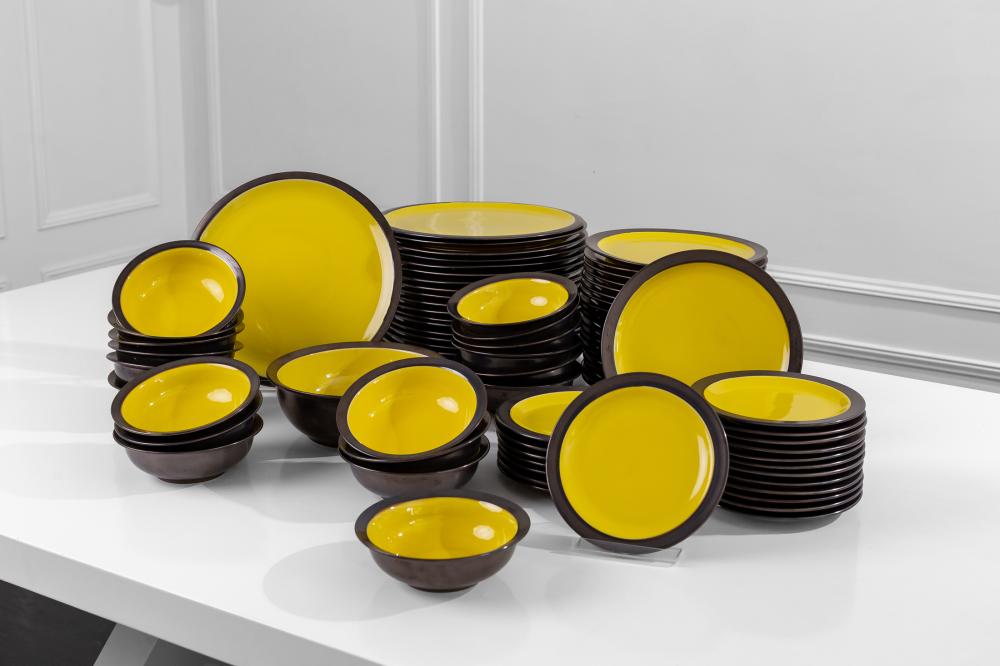 Appraisal: CHRISTIAN AUDIGIER SET OF CRATE BARREL DISHESyellow and brown-glazed ceramic