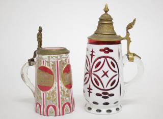 Appraisal: German Colored Glass Overlay Beer Steins Cranberry glass beer stein