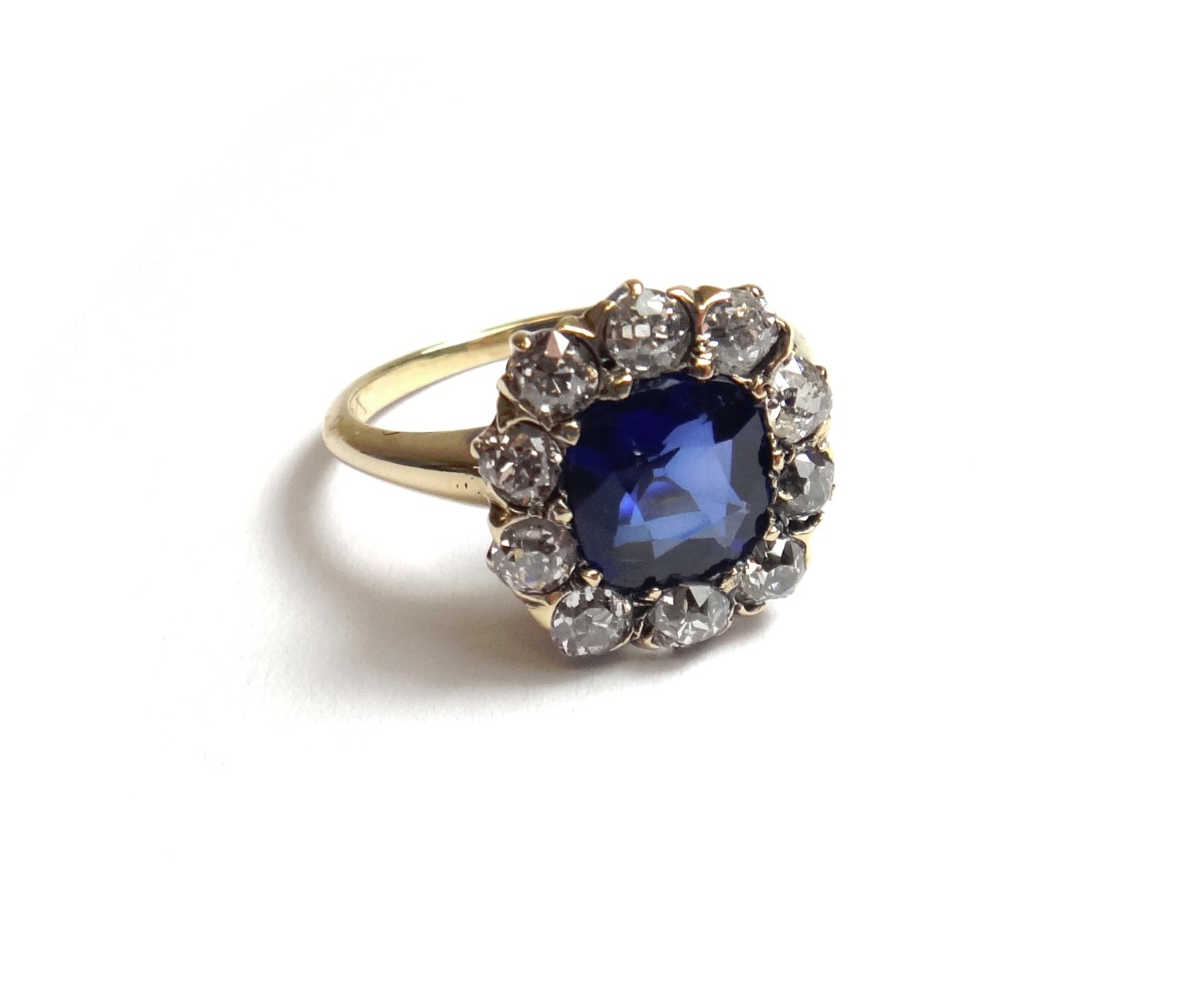 Appraisal: A gold synthetic sapphire and diamond set cluster ring mounted