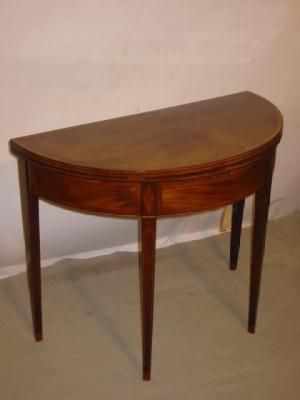 Appraisal: A GEORGE III MAHOGANY FOLDING TEA TABLE of demi lune