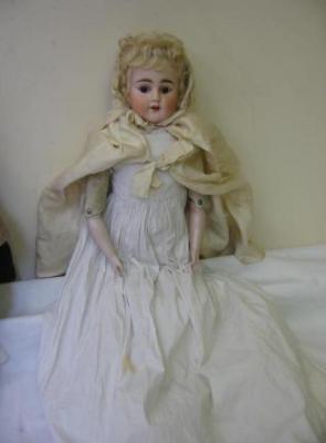 Appraisal: A bisque shoulder head doll with brown sleeping eyes open