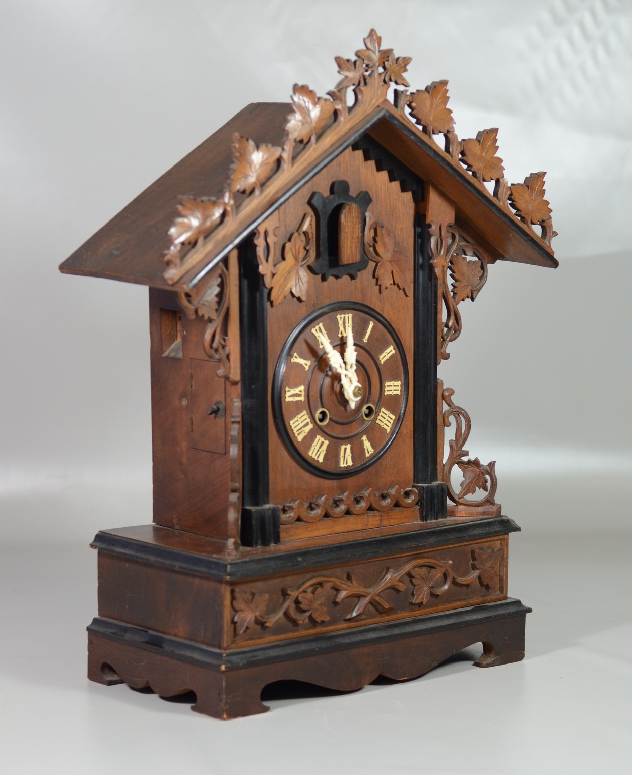 Appraisal: Carved walnut Black Forest mantle clock day brass movement a