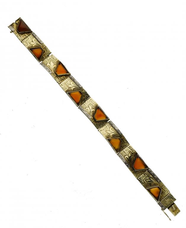 Appraisal: A GOLD BRACELET of engraved rectangular panels mounted with off-centre