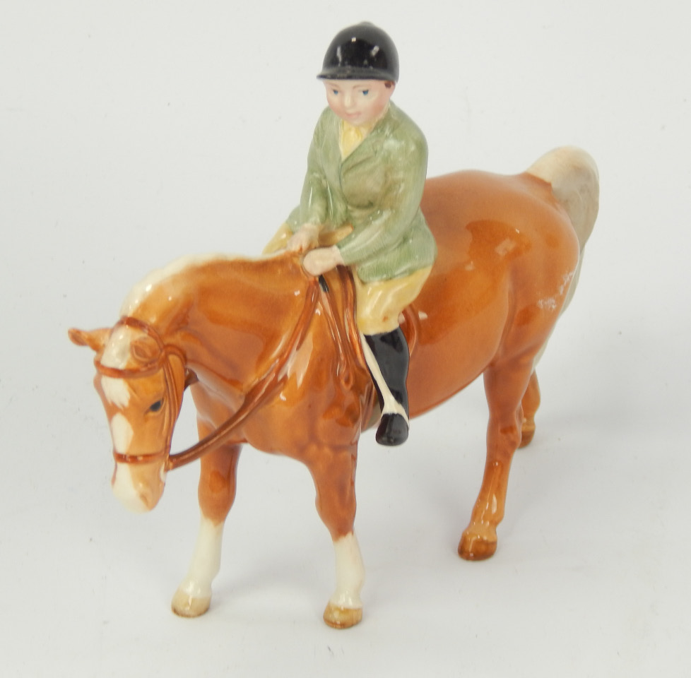 Appraisal: A Beswick model of a boy riding a Palomino pony