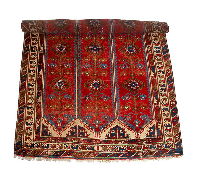 Appraisal: A WEST TURKISH RED GROUND RUG with three bands of