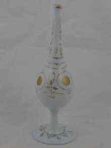 Appraisal: A slender milk glass rosewater bottle with applied gilt decoration