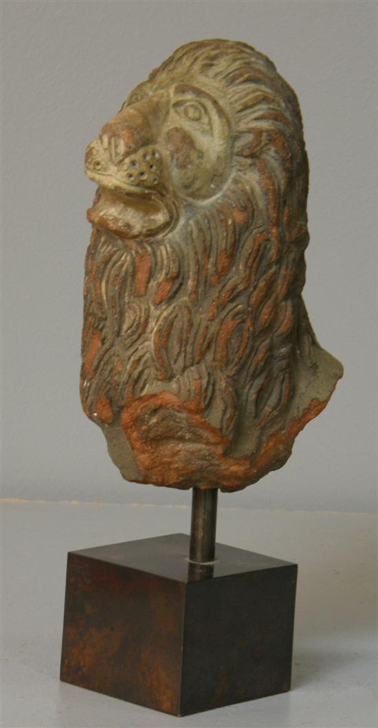 Appraisal: Terracotta lion's head possibly th century on polished sate and