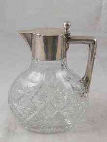 Appraisal: A cut glass claret jug with German silver mounts stamped