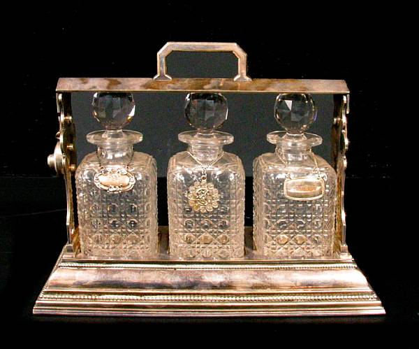 Appraisal: An English silverplated tantalus with crystal bottles height in width