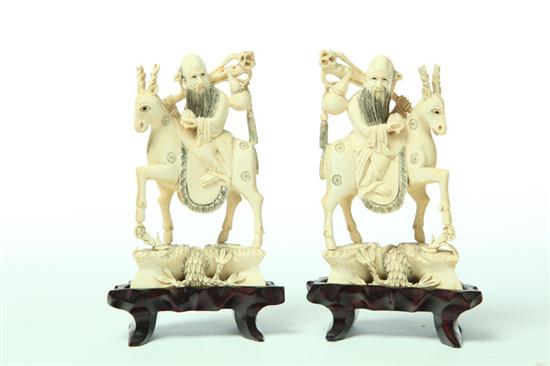 Appraisal: PAIR OF IVORY CARVINGS China st half- th century God