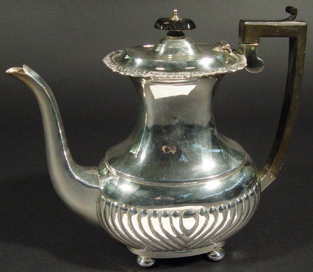 Appraisal: Edwardian silver hot water pot the body of half fluted