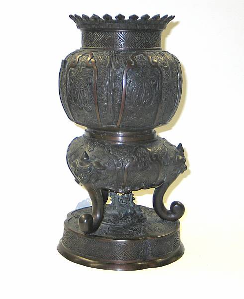 Appraisal: A cast bronze pieced censer The globular pomegranate shaped body