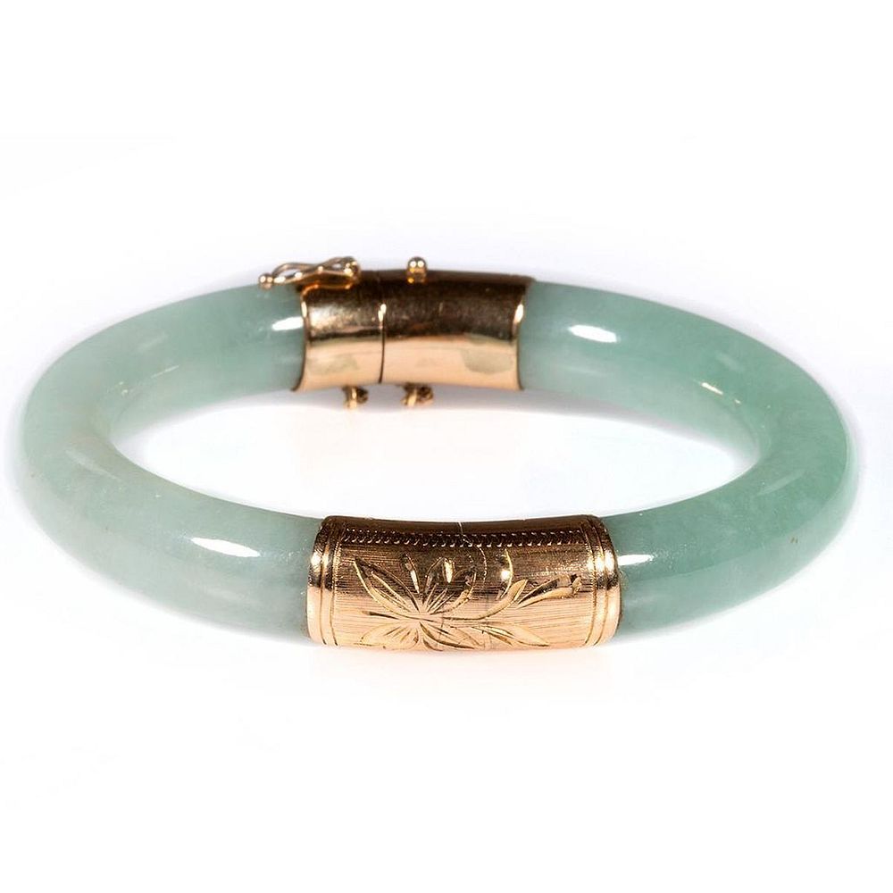 Appraisal: Jade and k gold hinged bangle bracelet the light green