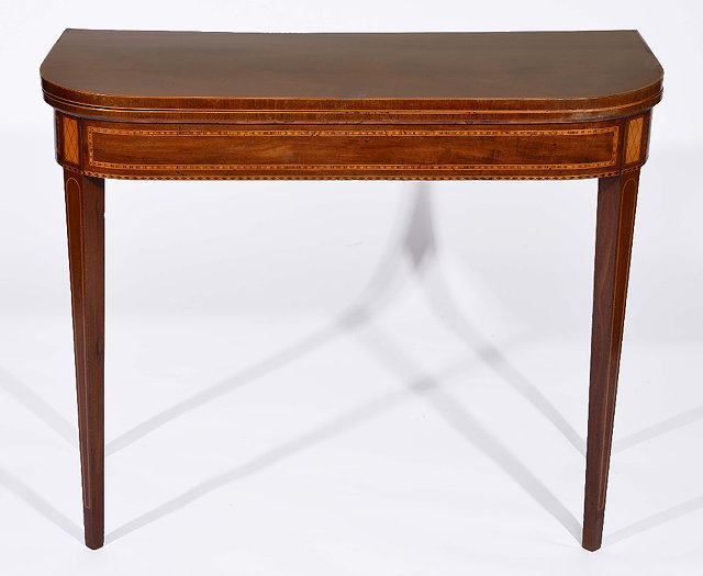 Appraisal: th Century mahogany fold-over tea tablewith satinwood border on tapering