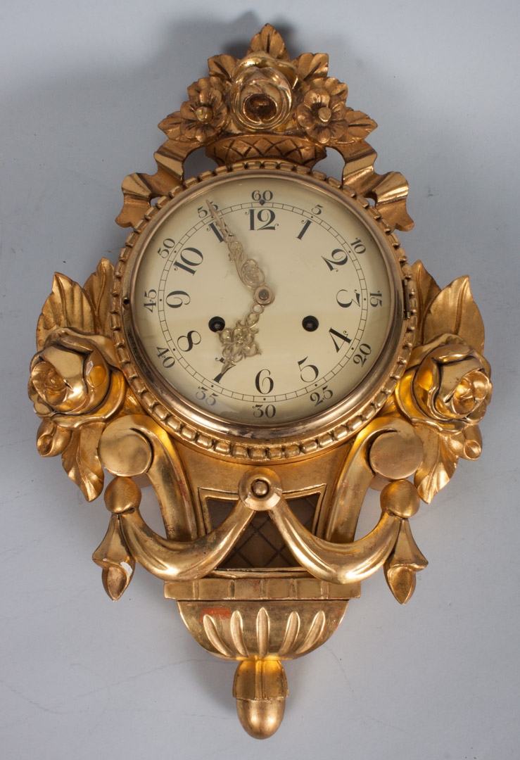 Appraisal: Rococo style giltwood wall clock floral basket finial and floral